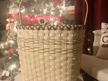 Finished tall rectangular basket with a dark-accented rim and swing handle, styled beside a decorated Christmas tree.
